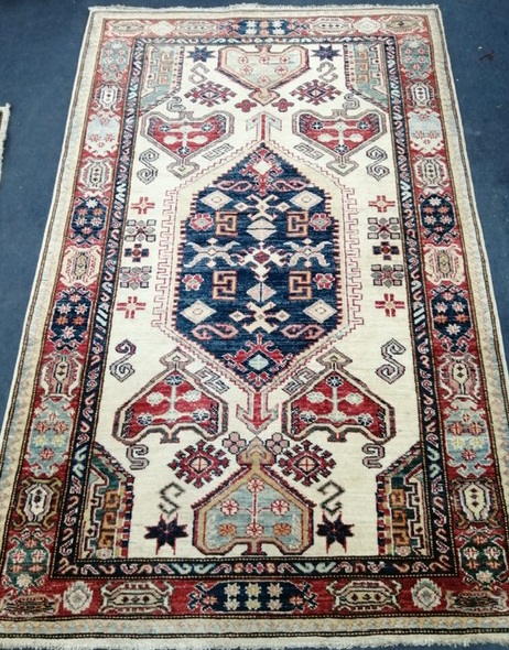 A Kazak style fawn ground rug Approx. 160 x 100cm